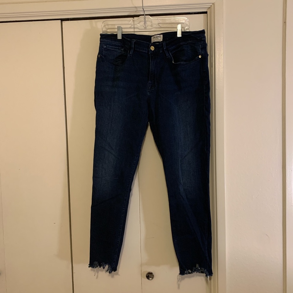 Frame dark jeans with distressed hem detail!